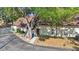 Cozy single story home with a brown roof, and a sidewalk leading to the front door, partially shaded by a mature tree at 12425 Touchton Dr # 77, Tampa, FL 33617