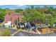 Low aerial shot of townhouse exteriors, showing roofing, trees and landscaping at 12425 Touchton Dr # 77, Tampa, FL 33617