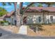 Single story home with a brown roof, a sidewalk leading to the front door, partially shaded by a mature tree at 12425 Touchton Dr # 77, Tampa, FL 33617