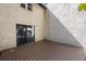 Private patio with composite decking and stucco wall has sliding glass doors to interior at 12425 Touchton Dr # 77, Tampa, FL 33617