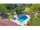 Aerial view of community pool with turquoise water, tennis court and shade trees at 12425 Touchton Dr # 77, Tampa, FL 33617