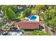 Aerial view of community pool with turquoise water, clubhouse and tennis courts at 12425 Touchton Dr # 77, Tampa, FL 33617