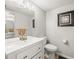 Clean half bathroom featuring a modern vanity with a sink, toilet and framed artwork at 1303 N Mcmullen Booth Rd # 1303, Clearwater, FL 33759