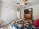 Bedroom with double closet, a dresser with a television, and neutral walls and carpet at 1303 N Mcmullen Booth Rd # 1303, Clearwater, FL 33759