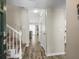 Inviting foyer with hardwood floors, staircase, coat closet and a view into the living room at 1303 N Mcmullen Booth Rd # 1303, Clearwater, FL 33759