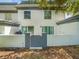 View of the building's rear exterior with sliding glass doors and an enclosed patio at 1303 N Mcmullen Booth Rd # 1303, Clearwater, FL 33759