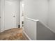 Hallway with white doors, leading to the bathroom with beige carpet and neutral walls at 1303 N Mcmullen Booth Rd # 1303, Clearwater, FL 33759