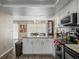 Open-concept kitchen leading into dining area, showcasing a modern design at 1303 N Mcmullen Booth Rd # 1303, Clearwater, FL 33759