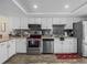 Bright kitchen with stainless steel appliances, white cabinets, and granite countertops at 1303 N Mcmullen Booth Rd # 1303, Clearwater, FL 33759