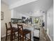 Kitchen with a breakfast bar, granite counters, and modern white cabinets at 1303 N Mcmullen Booth Rd # 1303, Clearwater, FL 33759