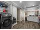 Open concept laundry room leading to the kitchen and dining area, featuring a washer at 1303 N Mcmullen Booth Rd # 1303, Clearwater, FL 33759