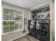 Convenient laundry room with large window and modern appliances at 1303 N Mcmullen Booth Rd # 1303, Clearwater, FL 33759