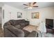 Welcoming living room with plush sectional, ceiling fan, neutral palette, and lots of natural light at 1303 N Mcmullen Booth Rd # 1303, Clearwater, FL 33759