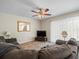 Comfortable living room with ceiling fan, plush sofa, neutral walls, and a patterned rug at 1303 N Mcmullen Booth Rd # 1303, Clearwater, FL 33759