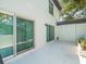 Enclosed outdoor patio with sliding glass door and an exterior door at 1303 N Mcmullen Booth Rd # 1303, Clearwater, FL 33759