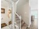 Staircase with carpet and white wooden banister, leading to a landing and half bathroom at 1303 N Mcmullen Booth Rd # 1303, Clearwater, FL 33759