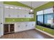 Bright dining area with custom cabinetry, bar fridge, and quartz countertops at 1310 Country Trails Dr, Safety Harbor, FL 34695