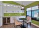 Bright dining area with custom cabinetry and countertops, a sleek bar fridge and a modern pendant light at 1310 Country Trails Dr, Safety Harbor, FL 34695