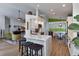 Open-concept kitchen with quartz countertops, breakfast bar, and views of the living area at 1310 Country Trails Dr, Safety Harbor, FL 34695