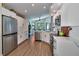 Bright kitchen features stainless steel appliances, white cabinets, and a modern open design at 1310 Country Trails Dr, Safety Harbor, FL 34695
