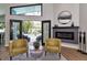 Stylish living room featuring a modern fireplace and patio doors opening to a private outdoor pool at 1310 Country Trails Dr, Safety Harbor, FL 34695