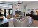 Elegant living room with modern furnishings, fireplace, and access to outdoor spaces at 1310 Country Trails Dr, Safety Harbor, FL 34695