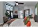 Bright bedroom featuring a modern ceiling fan, access to the pool area, and en-suite bathroom at 1310 Country Trails Dr, Safety Harbor, FL 34695