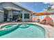 Backyard pool and spa featuring spacious patio, lounge chairs, and a serene outdoor space at 1310 Country Trails Dr, Safety Harbor, FL 34695
