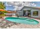 Beautiful pool and spa with landscaped surroundings, perfect for relaxation and outdoor entertainment at 1310 Country Trails Dr, Safety Harbor, FL 34695