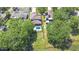 Aerial view of a property with a pool and well-manicured lawn, complemented by a scenic lake backdrop at 1324 Eckles Dr, Tampa, FL 33612