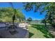 Backyard patio with outdoor dining, in-ground pool, lush landscaping, and serene views of the lake at 1324 Eckles Dr, Tampa, FL 33612