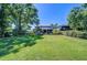 Large, lush backyard featuring mature trees and outdoor seating area, ideal for entertaining guests at 1324 Eckles Dr, Tampa, FL 33612