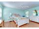 Bright bedroom with light blue walls and tropical-themed bedding at 1324 Eckles Dr, Tampa, FL 33612
