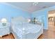 Bright bedroom with a white sleigh bed and light blue walls, complemented by hardwood floors at 1324 Eckles Dr, Tampa, FL 33612