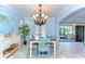 Charming dining room with large windows, chandelier and modern coastal furnishings at 1324 Eckles Dr, Tampa, FL 33612