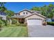 Charming two-story home with a well-manicured lawn and attached two car garage at 1324 Eckles Dr, Tampa, FL 33612