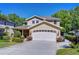 Inviting home featuring a large driveway and a two-car garage with decorative windows at 1324 Eckles Dr, Tampa, FL 33612