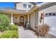 Welcoming entrance features an arched wood door, brick walkway, and manicured landscaping at 1324 Eckles Dr, Tampa, FL 33612