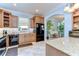 Open kitchen area with stainless appliances, granite countertops, lots of wood cabinets and tile floors at 1324 Eckles Dr, Tampa, FL 33612