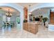Open floor plan with kitchen island, wood cabinetry, granite counters, and stainless appliances at 1324 Eckles Dr, Tampa, FL 33612