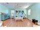 Cozy living room featuring light blue walls and beach-themed decor at 1324 Eckles Dr, Tampa, FL 33612