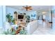 Bright and airy living room with tile floors, ceiling fan, and lots of plants at 1324 Eckles Dr, Tampa, FL 33612
