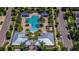 Aerial shot of the community pool and amenity center, highlighting palm trees and a well-manicured lawn at 13355 Palmerston Rd, Riverview, FL 33579