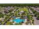 An aerial view of a community featuring a pool, playground, and gazebo nestled among lush landscaping and homes at 13355 Palmerston Rd, Riverview, FL 33579