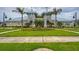 View of the amenity center showcasing well-kept lawns and tropical landscaping at 13355 Palmerston Rd, Riverview, FL 33579
