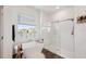 Bright bathroom featuring a soaking tub, glass enclosed shower and wood floors at 13355 Palmerston Rd, Riverview, FL 33579