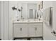 Stylist bathroom features a double sink vanity with white cabinets and modern fixtures at 13355 Palmerston Rd, Riverview, FL 33579