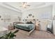 Spacious bedroom with a tray ceiling, soft carpet, dresser, and decor at 13355 Palmerston Rd, Riverview, FL 33579