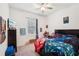 Well-lit bedroom with soft carpet, ceiling fan, and closet with plenty of shelf space at 13355 Palmerston Rd, Riverview, FL 33579