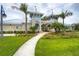 The clubhouse welcomes residents with a stone walkway, lush lawn, and tropical landscaping at 13355 Palmerston Rd, Riverview, FL 33579